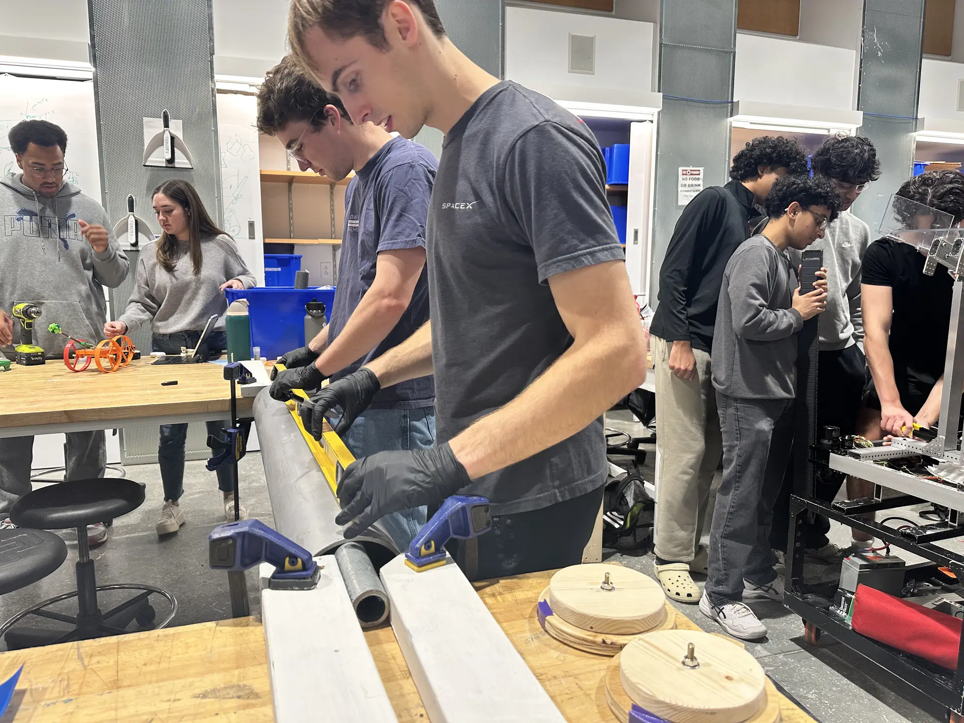 Students manufacturing a structure's component