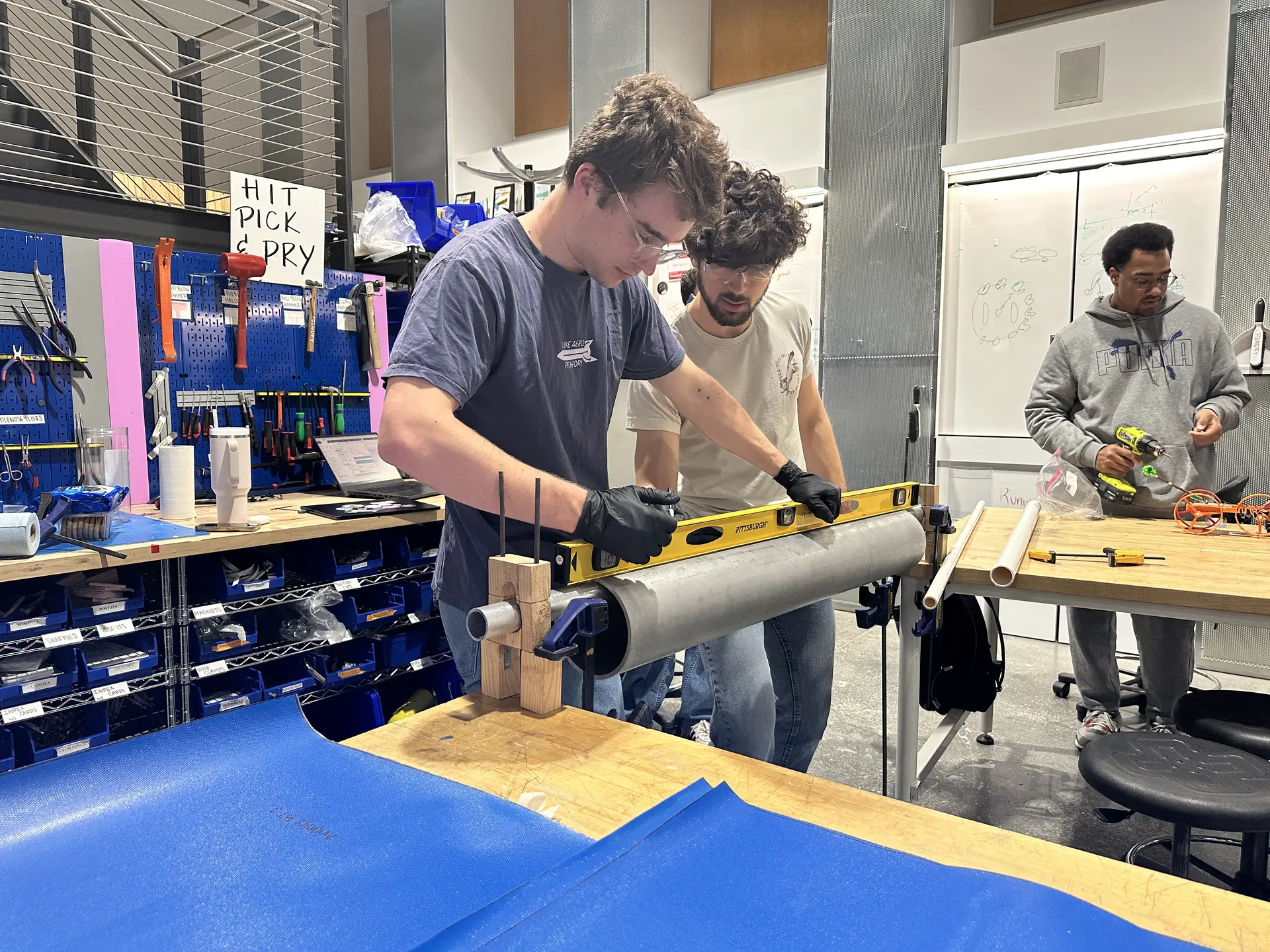 Students manufacturing a structure's component