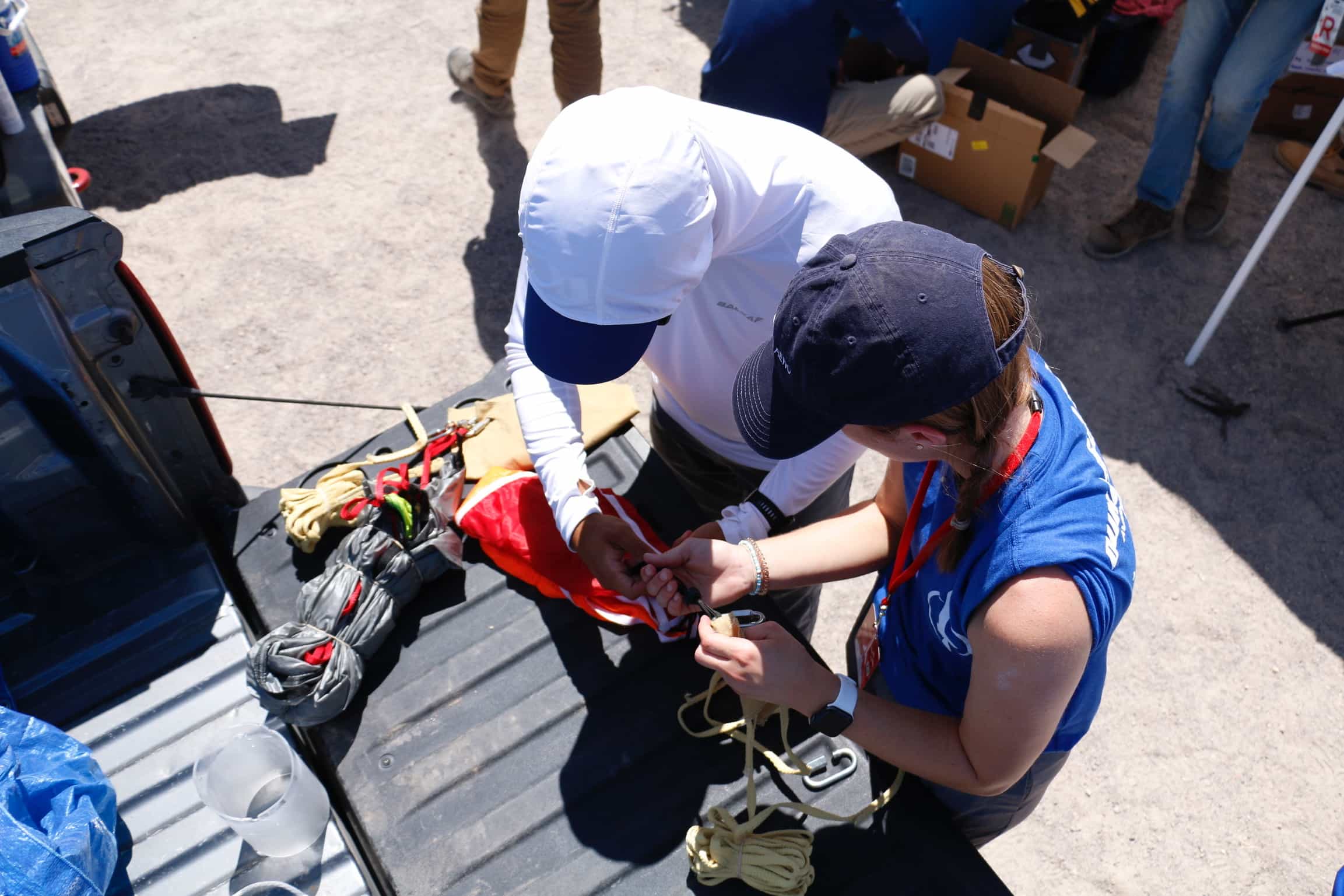 members working on packing parachutes