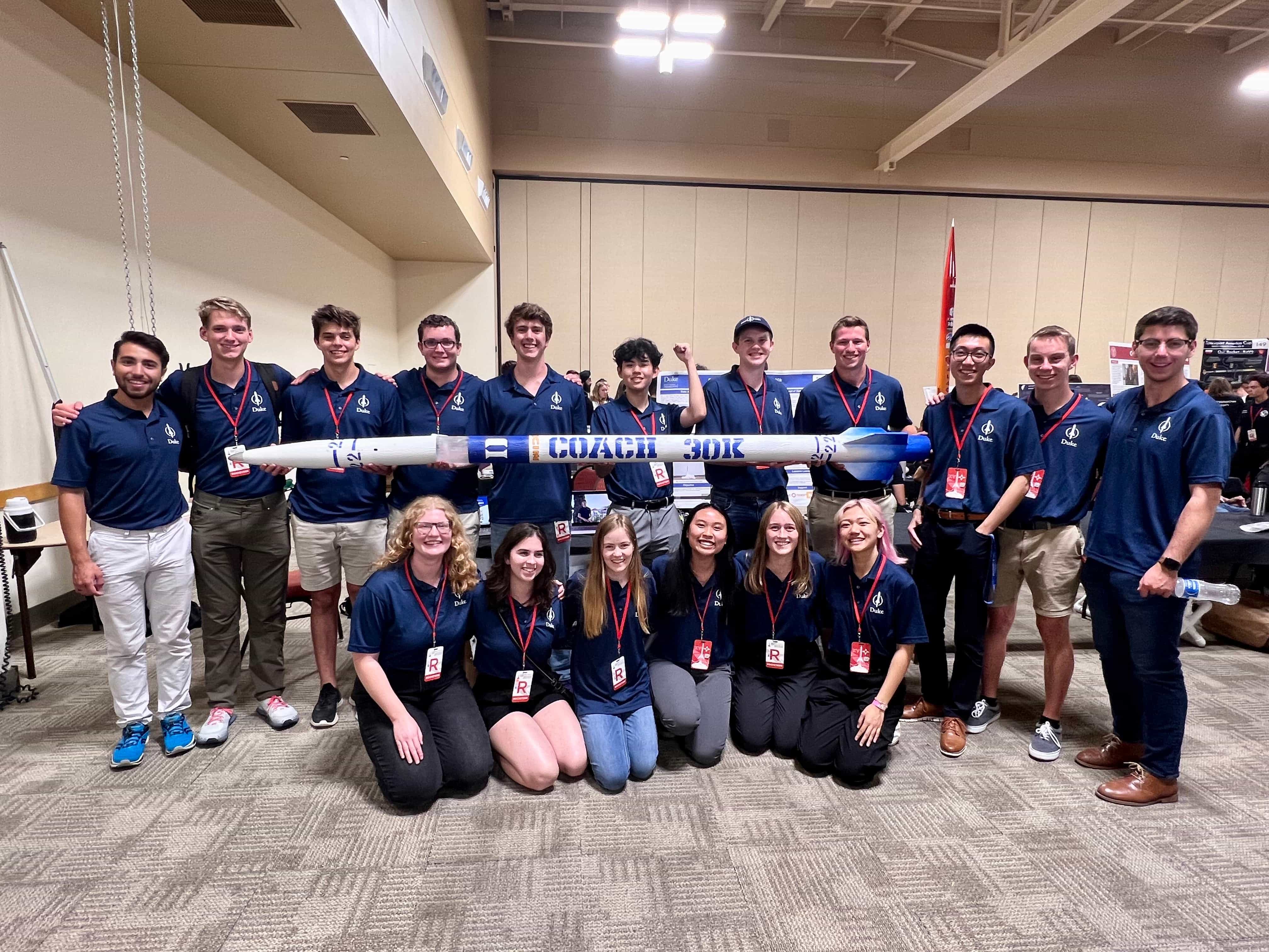 team photo with rocket in the convention hall